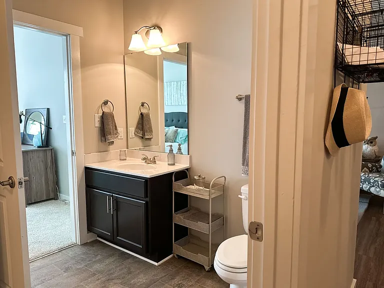 Shown here, is the bathroom of a 1-bedroom Emeline floorplan. The room is accessed by both the bedroom and the entryway, ensuring that your guests never have to enter your personal space to access the bathroom.