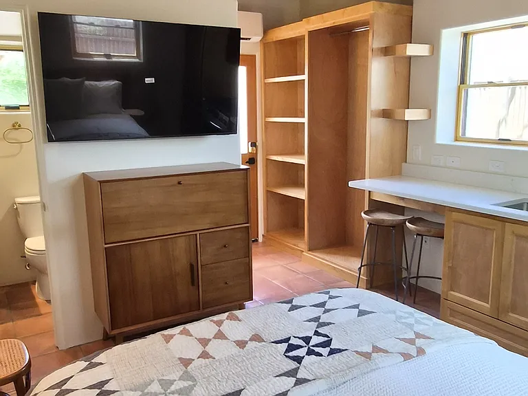 custom cabinetry including shelving and a wardrobe