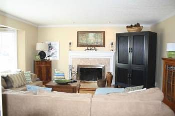 French doors open to this beautiful living room featuring bay window, fireplace, hardwood flooring, 