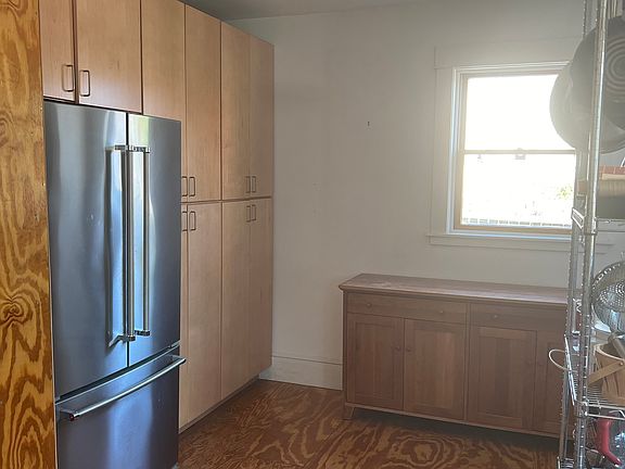 Refrigerator, built-in bookshelves, and large cabinets.