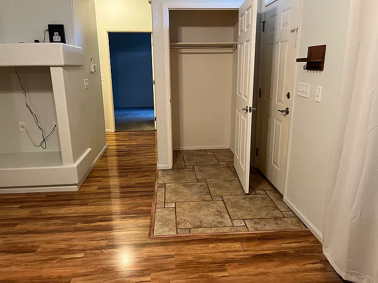 View of hall closet and hallway to bedrooms and bathrooms.