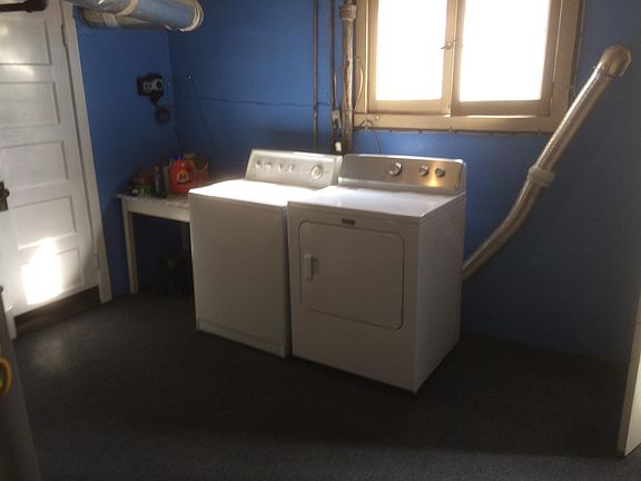 Shared laundry in basement where extra storage unit for each upstairs and downstairs tenants.