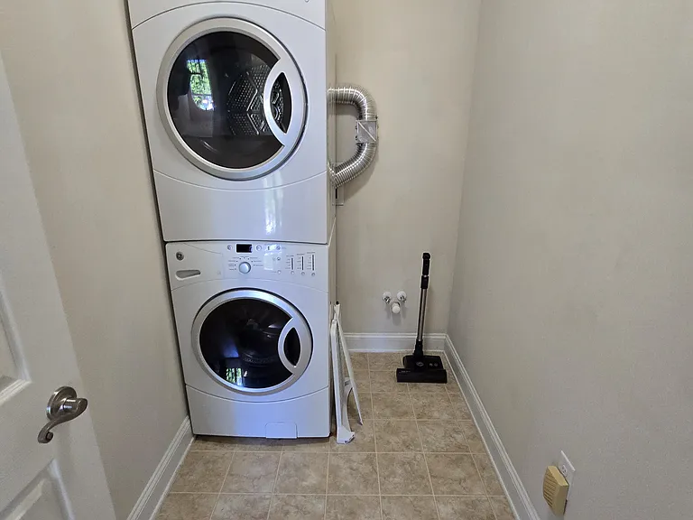 Room on third floor with washer and dryer and home vacuum system.