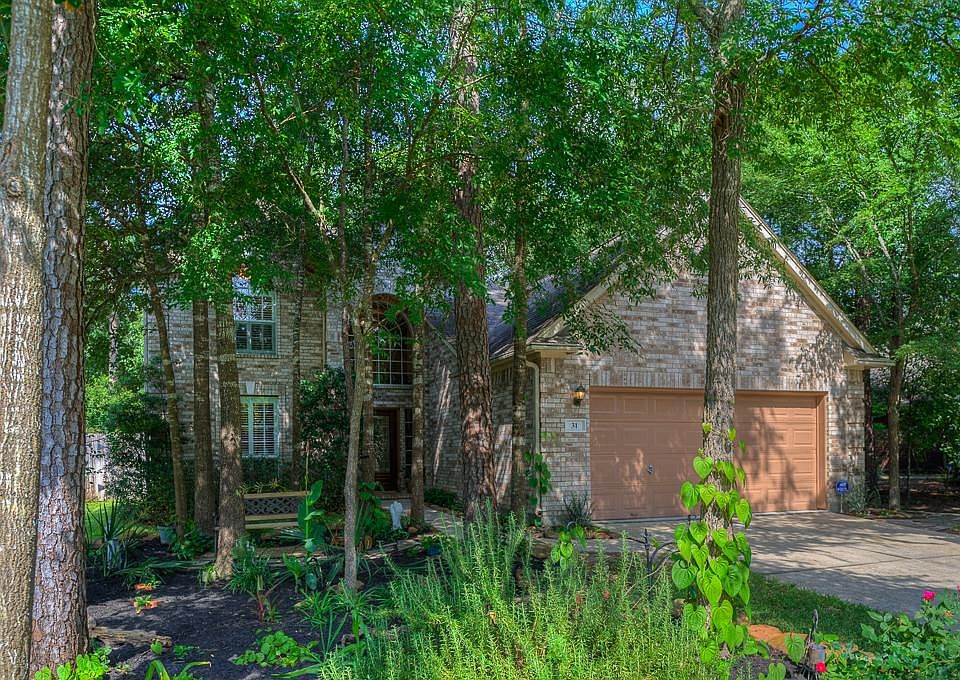 Beautifully landscaped front yard with lots of pretty shade trees