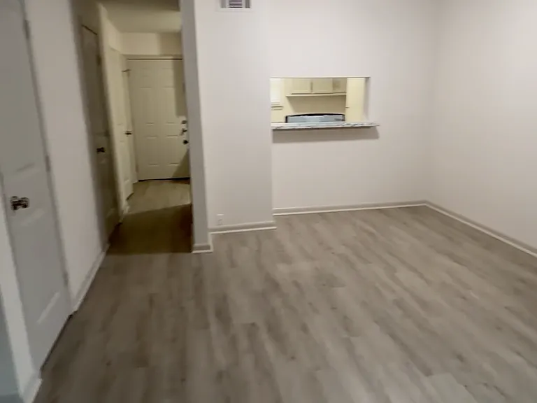 Open and spacious living room with modern flooring and a bright layout - perfect for entertaining or relaxing.
