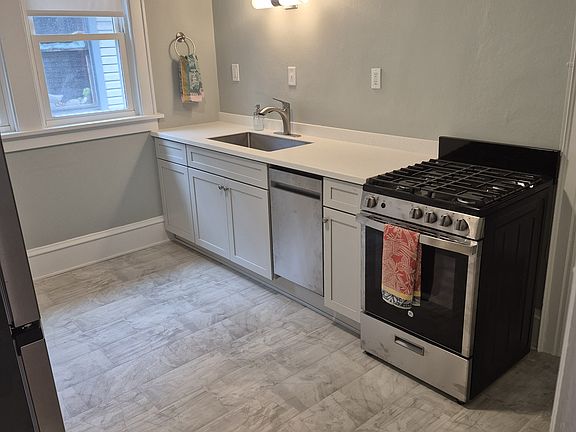 Kitchen, View 1. Brand new quartz countertops, all new appliances including dishwasher. New flooring.