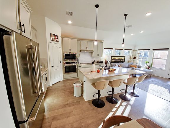 Kitchen with Quartz-top island and bar stools