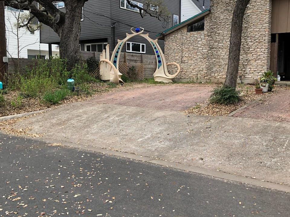 off street paring for 2 vehicles, large live oak and original sculpture in front.