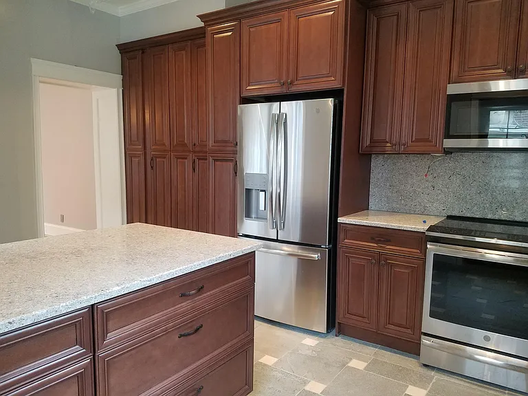 Eat-in Kitchen with induction range, microwave hood, EnergyStar refrigerator, stone countertops and backsplash. Great storage.