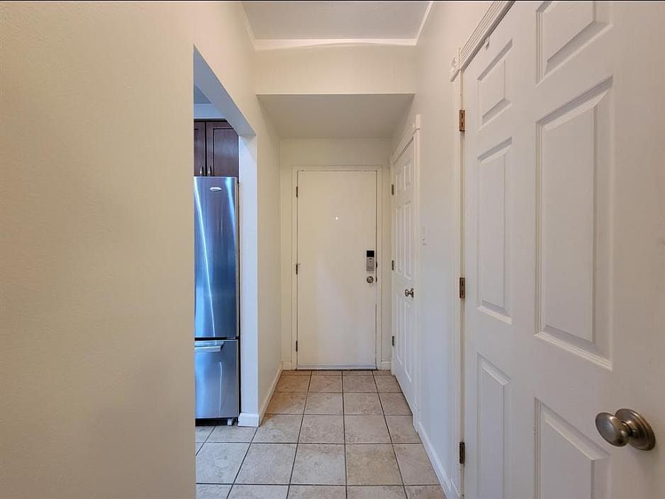 View of front door from inside (laundry closet and half bath are to the right, kitchen to the left)