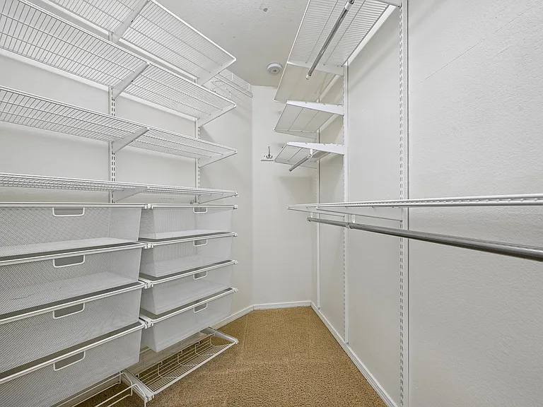 Walk in Primary closet with built in storage.