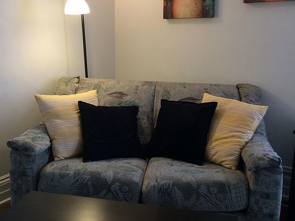 living room sofa, carpeted over hardwood floors