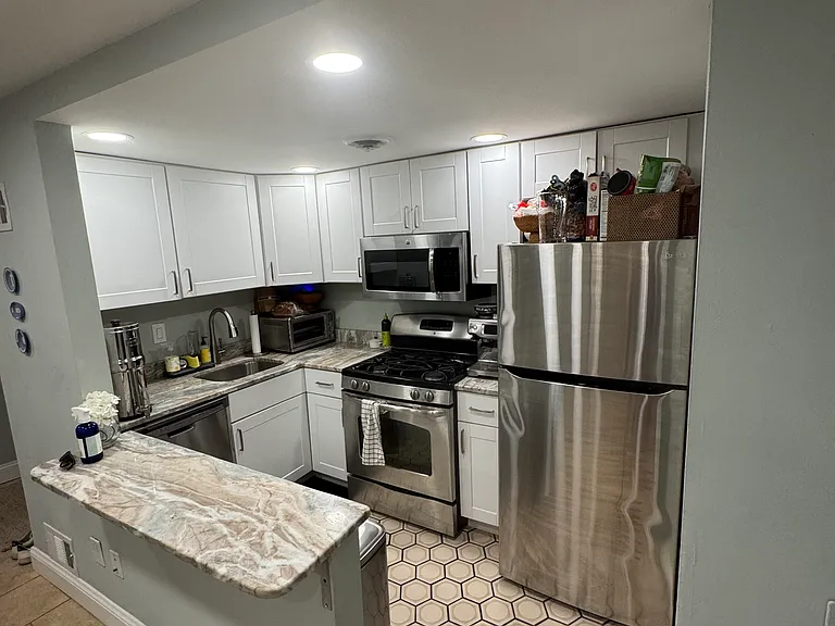 Newly updated kitchen. Great stainless steel appliances and overhanging counter top for quick meals.
