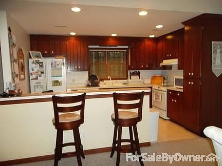 Kitchen with Eat-in Bar
						:
						Many cabinets and more in large utility room. Bar will accommodate 4 stools.