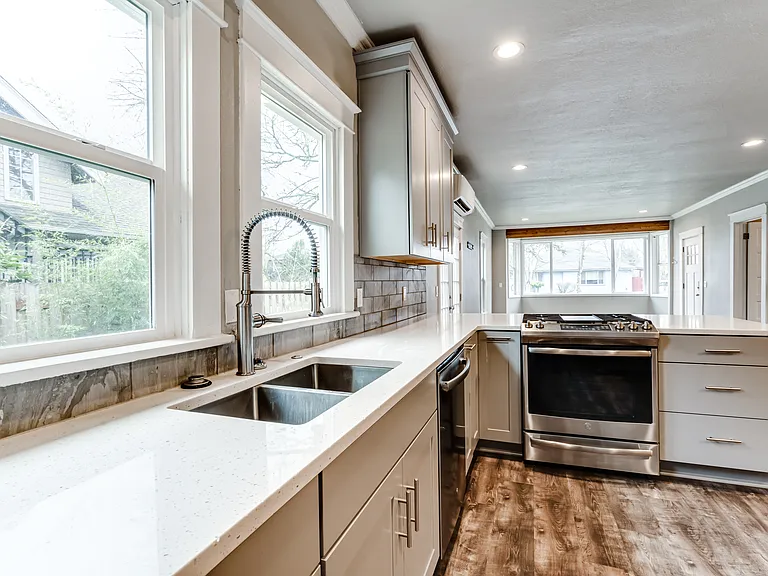 Enjoy the oversized sink area with commercial style faucet. Not to mention a view of the side yard.