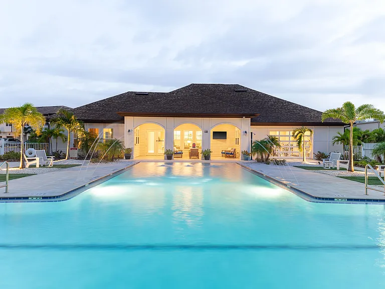 Experience serene living in this elegant complex featuring a captivating poolside view.