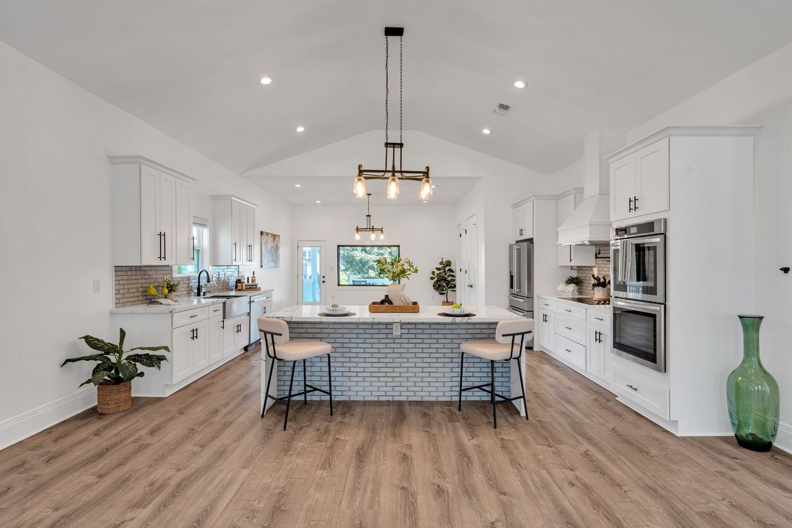 Large open kitchen centered around an oversized island with seating and generous workspace.