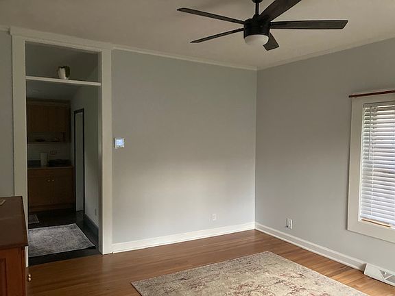Living room with freshly painted walls and refinished hardwood floors
