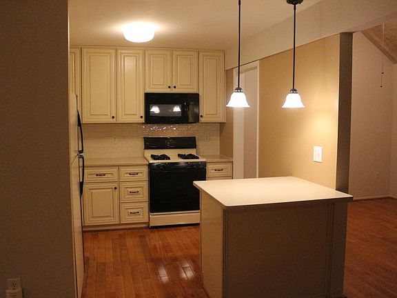 Soft close cabinets with quartz countertops and NEW black and stainless oven installed 2024.
