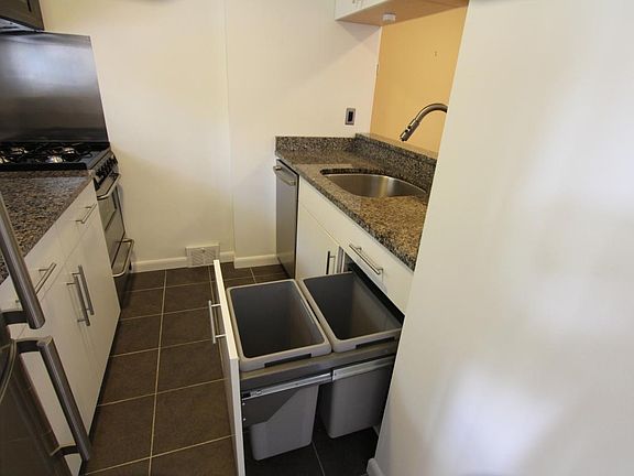 Kitchen with trash and recycle bins