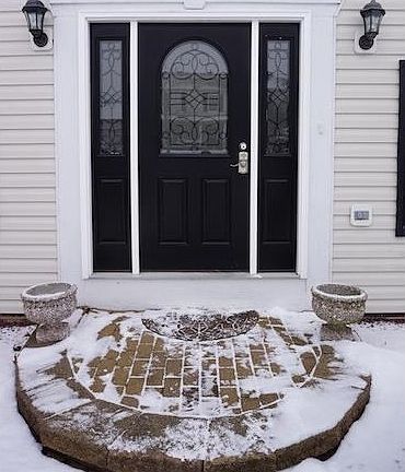 Stunning updated exterior door and omni stone lead walk.