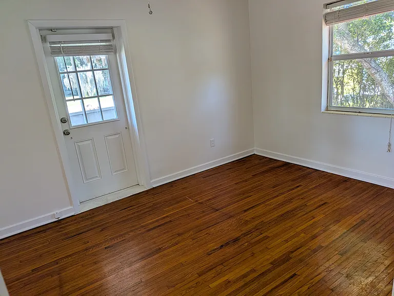 Opposite end of bedroom. The door opens to a small screened patio.
