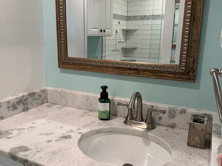 Primary bath with new walk in shower. Marble counter.