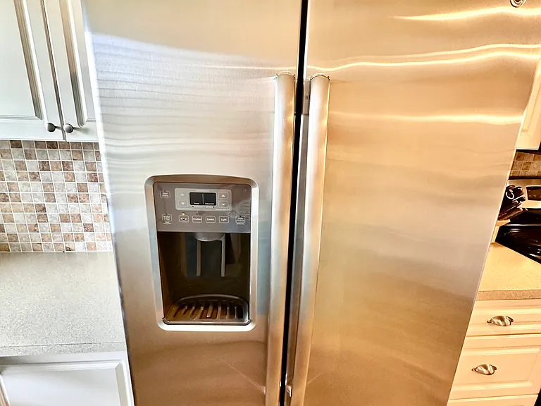 A kitchen that really performs. _ From the upgraded cupboards to the large-capacity fridge, we've made sure Unit 1003 is fully equipped for a long-term stay. Keep your drinks ice-cold and your groceries fresh in this clean, modern space.
