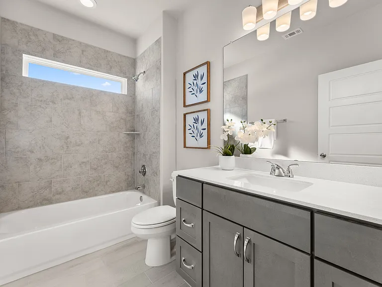 Second bathroom has a tub and shower combination and plenty of storage.