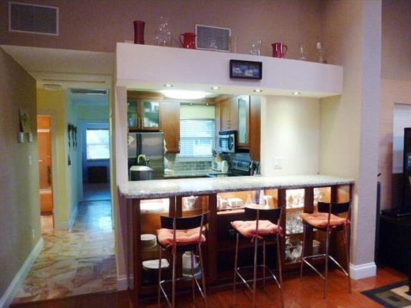 Kitchen with bar style granite counter that opens to the liv
