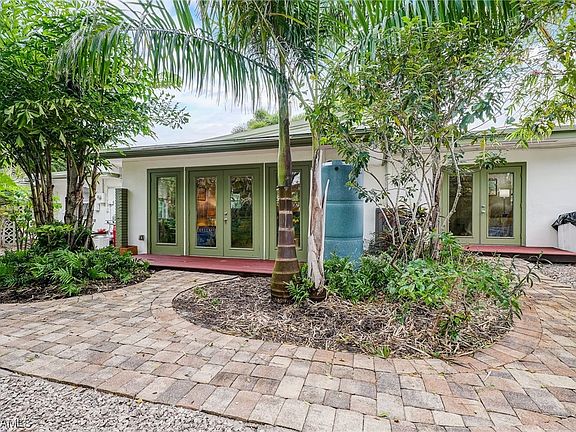 French doors from main bedroom and living room lead to tropical oasis