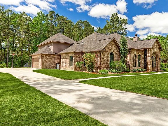 Basketball goal is excluded from sale. This photo shows how great this driveway lay out is. Room for extra parking, three car garage and it shows how the gameroom upstairs is configured in relationship to the rest of the house.