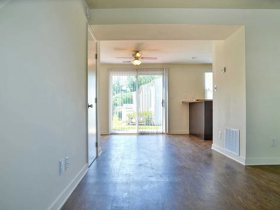 Spacious living and dining area with patio access at Lake Village Apartments