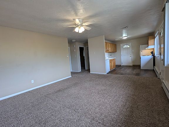 The large living room features a ceiling fan, and the apartment is equipped with central air conditioning.