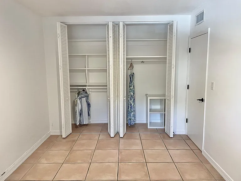 Tall double closets in second bedroom