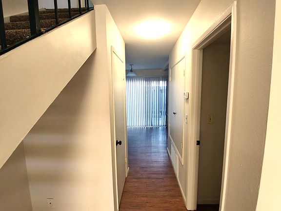 View from front door, living room is to the right, dining room and kitchen are straight ahead, laundry/half bath are the door you see to the right