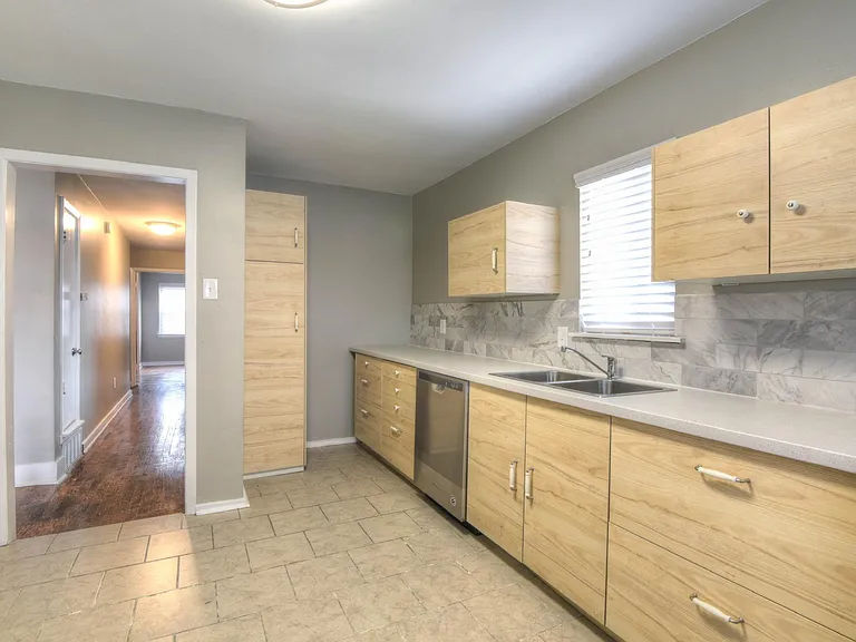Kitchen includes custom backsplash
