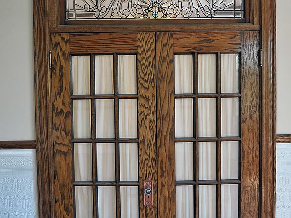FRENCH DOORS WITH BEVELLED STAINED GLASS WINDOW LEADING TO THE 1ST BEDROOM