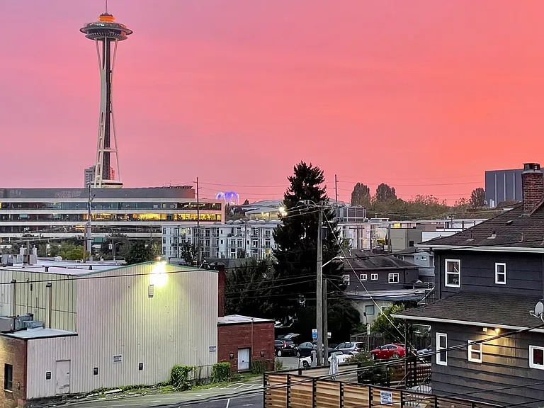 Looking out the living room window - orange sky and top of Needle.