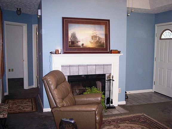 entry way showing tiled fireplace