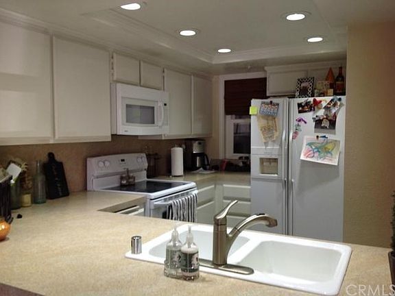 Lots of storage, electric stove, built-in microwave - kitchen was upgraded with newer counters, recessed lighting, easy care tile flooring