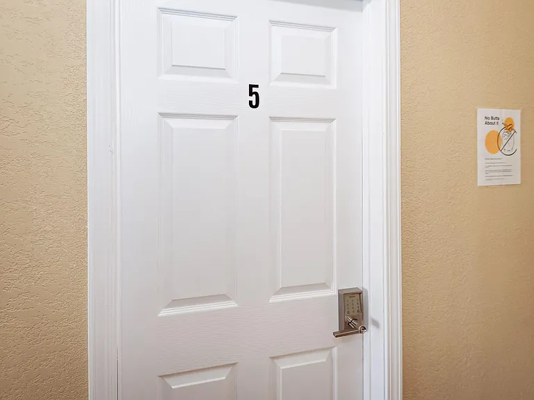 Interior entry area with a numbered door and keypad lock for convenient access.