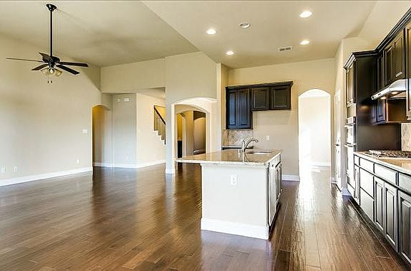 Beautiful kitchen opens to breakfast and family room with wood flooring throughout
