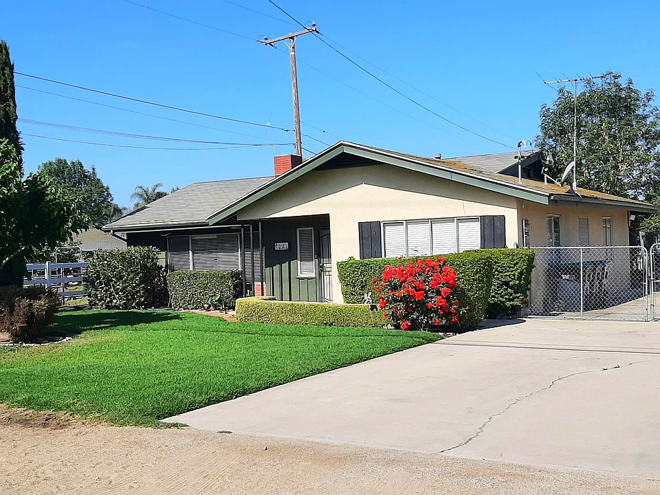 Front of House with Long Cement Driveway leading to Garage