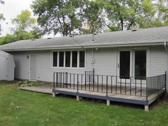 Deck and partially fenced backyard right of kitchen/dining r