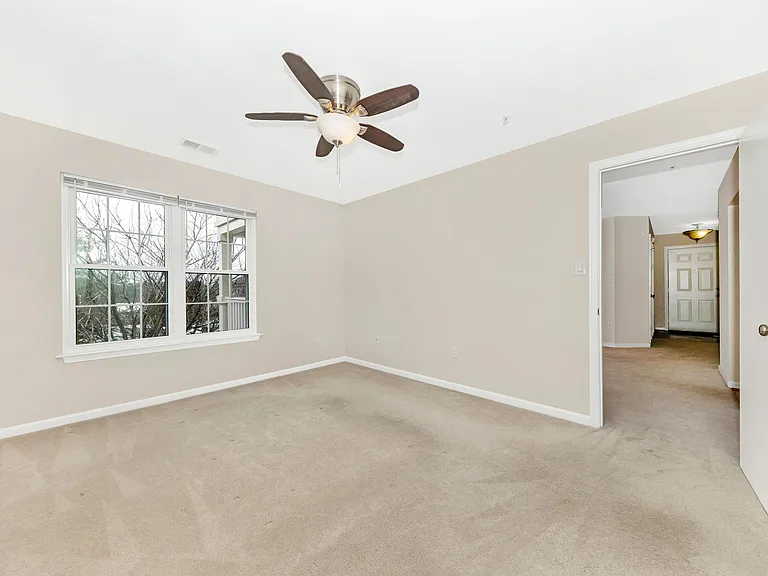 Primary bedroom off of living room, unstaged.