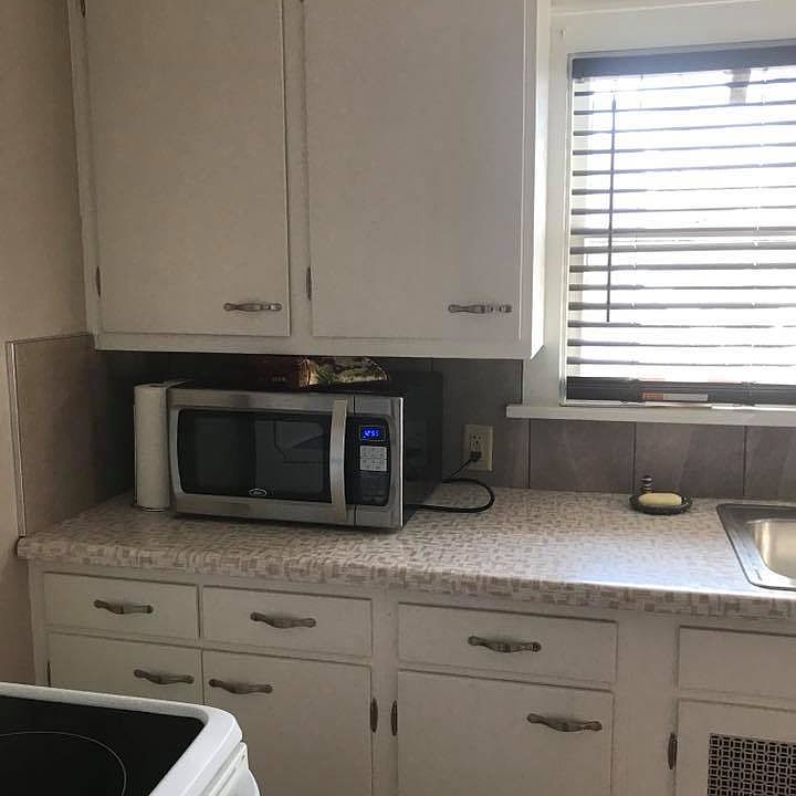 Kitchen microwave, counter, sink area
