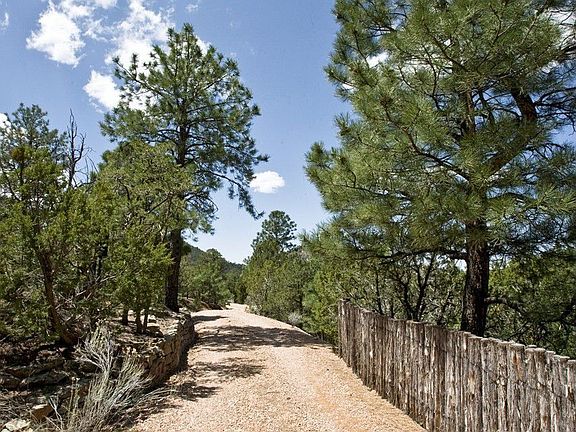 The surrounding acreage is thick with mountain greenery.