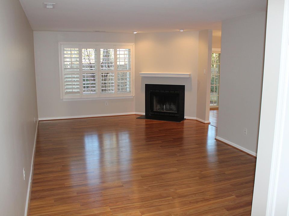 Welcoming entry way with coat closet and wood burning fireplace in the living room.