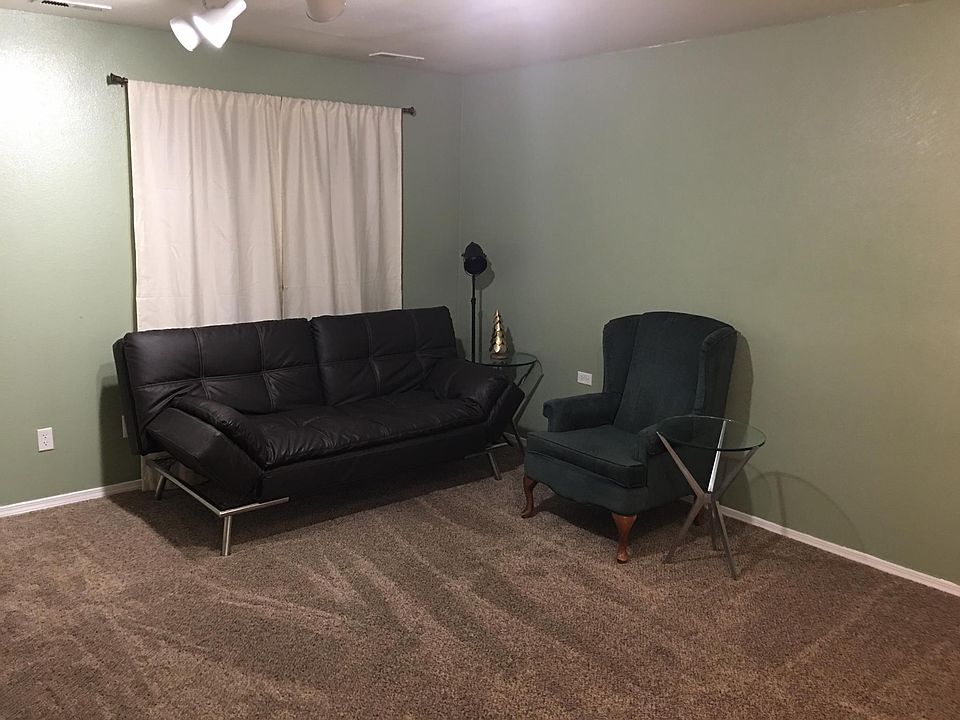 The front with the futon and winged chair